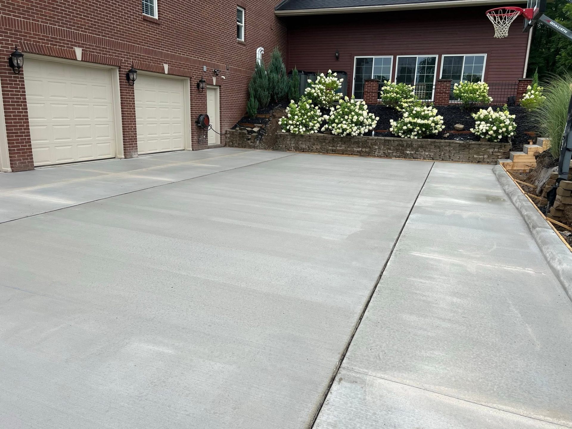 Freshly finished concrete driveway in front of a Metro Detroit home